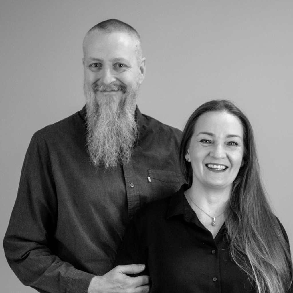 Two people standing together smilling, blank and white picture