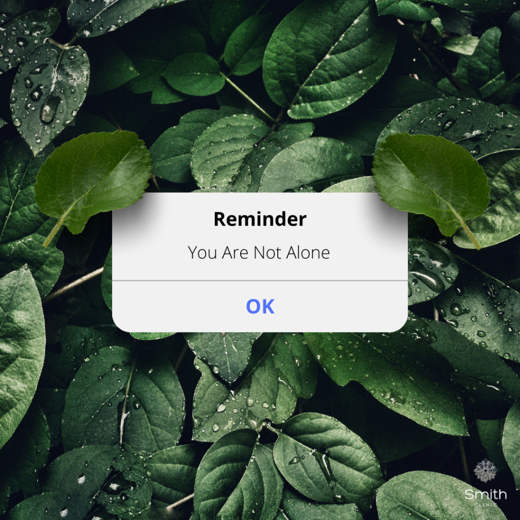 Reminder Not Alone You are not alone with a sign that looks like no battery and green folhage